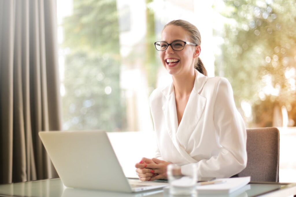 Happy person using a laptop.